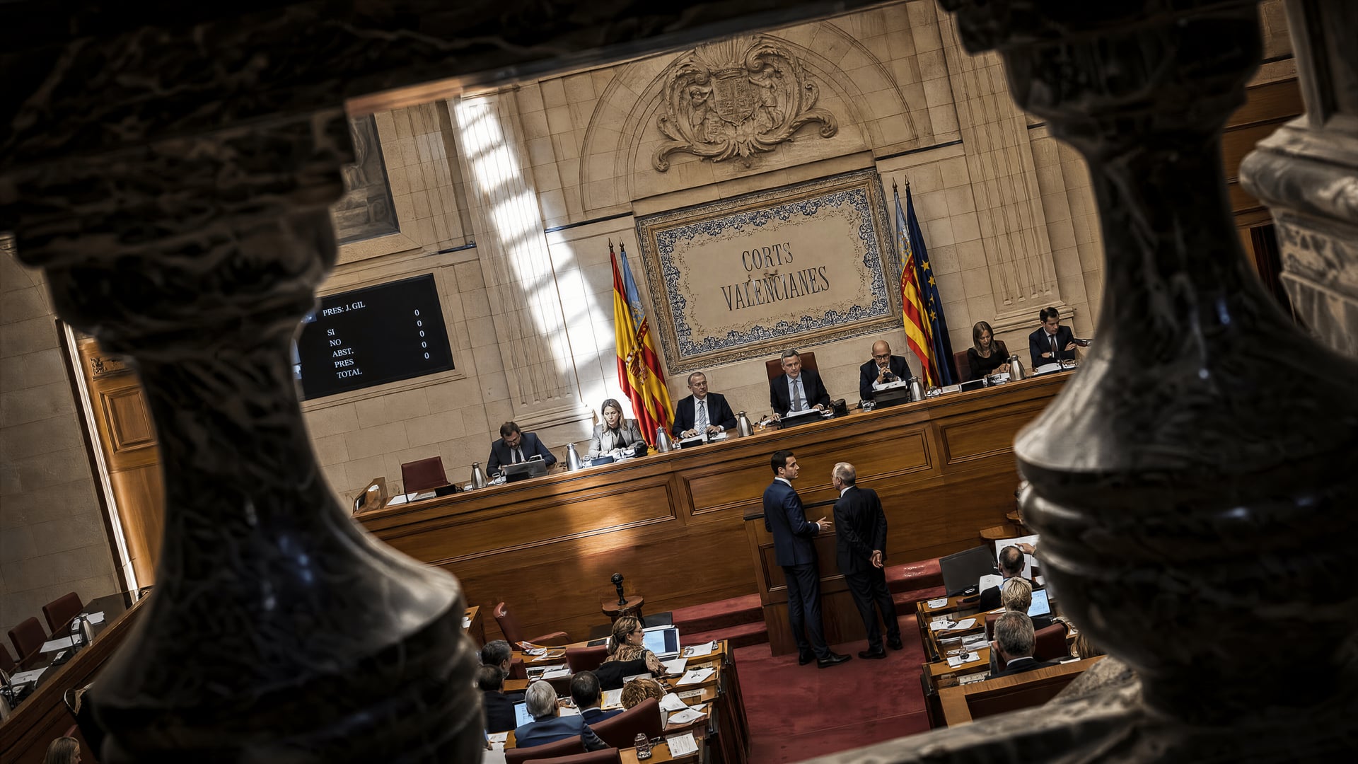 Corts Valencianes chamber with officials reviewing documents for the Valencian wealth-tax exemption